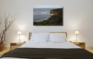 An acrylic print of a calm and overcast day at Bells Beach VIC hanging in a bed room setting