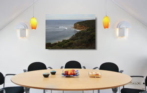 An acrylic print of a calm and overcast day at Bells Beach VIC hanging in a dining room setting