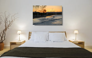 An acrylic print of a nice sunset at Belongil Beach, Byron Bay NSW hanging in a bed room setting