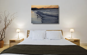 An acrylic print of Belongil Beach at Byron Bay NSW hanging in a bed room setting