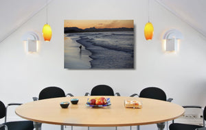 An acrylic print of Belongil Beach at Byron Bay NSW hanging in a dining room setting