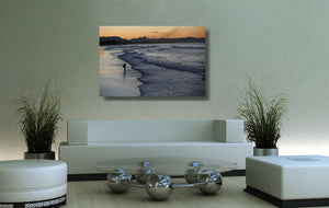 An acrylic print of Belongil Beach at Byron Bay NSW hanging in a lounge room setting