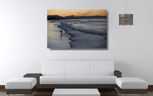 An acrylic print of Belongil Beach at Byron Bay NSW hanging in a lounge room setting