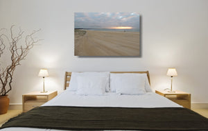 An acrylic print of a fisherman at sunrise at Blacksmiths Beach NSW hanging in a bed room setting