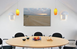 An acrylic print of a fisherman at sunrise at Blacksmiths Beach NSW hanging in a dining room setting