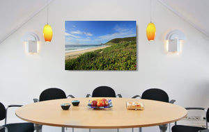 An acrylic print of a perfect sunny day at Blueys Beach NSW hanging in a dining room setting