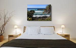 An acrylic print of Burleigh Heads on the Gold Coast, QLD hanging in a bed room setting