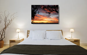 An acrylic print of a colourful sunset in Tamworth NSW in hanging in a bed room setting