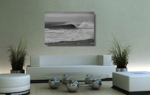 An acrylic print of a wave breaking at Sandon Point NSW hanging in a lounge room setting