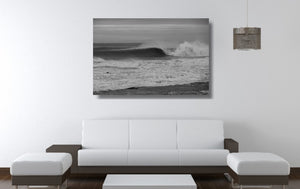 An acrylic print of a wave breaking at Sandon Point NSW hanging in a lounge room setting