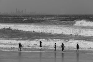Black and white photograph of waves, people and buildings at Kirra Beach on the Gold Coast, QLD