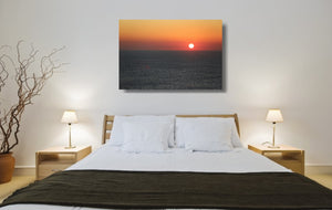 An acrylic print of a sunrise at Maroubra Beach NSW hanging in a bed room setting