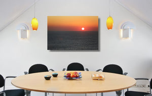 An acrylic print of a sunrise at Maroubra Beach NSW hanging in a dining room setting