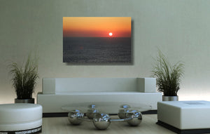 An acrylic print of a sunrise at Maroubra Beach NSW hanging in a lounge room setting