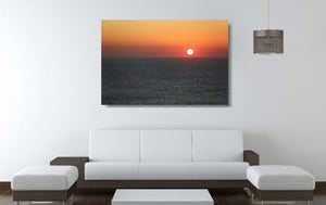 An acrylic print of a sunrise at Maroubra Beach NSW hanging in a lounge room setting