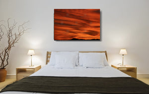 An acrylic print of a lunar landscape type sunset at Paradise Point QLD in hanging in a bed room setting