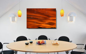 An acrylic print of a lunar landscape type sunset at Paradise Point QLD in hanging in a dining room setting