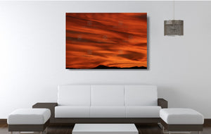 An acrylic print of a lunar landscape type sunset at Paradise Point QLD in hanging in a lounge room setting