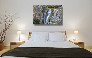 An acrylic print of Minyon Falls in NSW hanging in a bed room setting