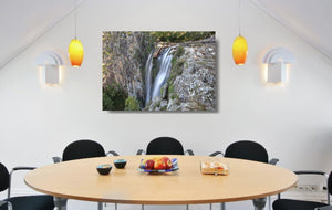 An acrylic print of Minyon Falls in NSW hanging in a dining room setting