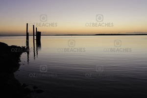 Photograph of a glassy ocean and piers at Dunwich Jetty, North Stradbroke Island QLD