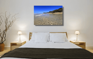 An acrylic print of the crystal clear waters of Cylinder Beach on North Stradbroke Island QLD hanging in a bed room setting