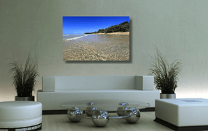 An acrylic print of the crystal clear waters of Cylinder Beach on North Stradbroke Island QLD hanging in a green lounge room setting