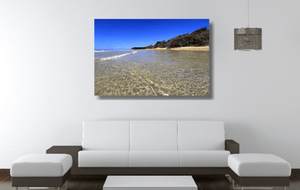 An acrylic print of the crystal clear waters of Cylinder Beach on North Stradbroke Island QLD hanging in a lounge room setting