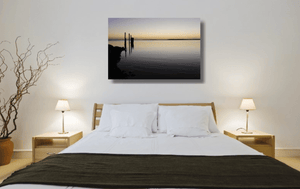 An acrylic print of sunset at Dunwich Jetty on North Stradbroke Island QLD hanging in a bed room setting