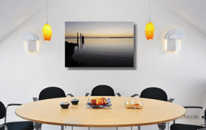 An acrylic print of sunset at Dunwich Jetty on North Stradbroke Island QLD hanging in a dining room setting
