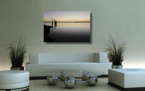 An acrylic print of sunset at Dunwich Jetty on North Stradbroke Island QLD hanging in a green lounge room setting