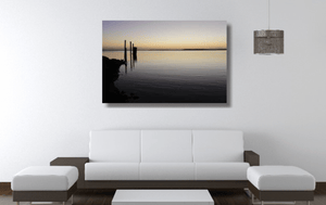 An acrylic print of sunset at Dunwich Jetty on North Stradbroke Island QLD hanging in a lounge room setting