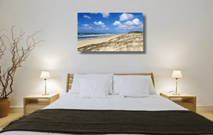 An acrylic print of Main Beach at Point Lookout on North Stradbroke Island QLD hanging in a bed room setting