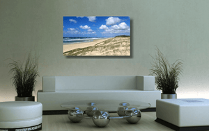 An acrylic print of Main Beach at Point Lookout on North Stradbroke Island QLD hanging in a green lounge room setting
