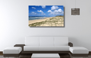 An acrylic print of Main Beach at Point Lookout on North Stradbroke Island QLD hanging in a lounge room setting