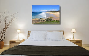 An acrylic print of Point Lookout Beach on North Stradbroke Island QLD hanging in a bed room setting