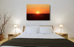 An acrylic print of a perfect sunset in outback NSW hanging in a bed room setting