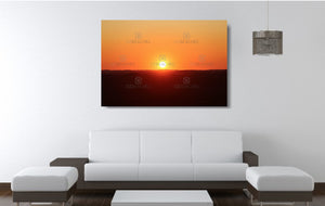 An acrylic print of a perfect sunset in outback NSW hanging in a lounge room setting