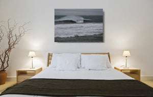 An acrylic print of Sandon Point in Wollongong NSW hanging in a bed room setting
