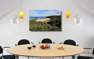 An acrylic print of Rennies Beach in Ulladulla NSW hanging in a dining room setting