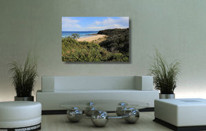 An acrylic print of Rennies Beach in Ulladulla NSW hanging in a lounge room setting