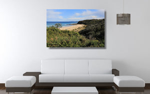 An acrylic print of Rennies Beach in Ulladulla NSW hanging in a lounge room setting