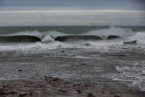 Photograph of a large wave breaking in two sections at Sandon Point NSW