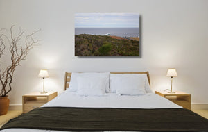 An acrylic print of a wave breaking off Surfers Point at Margaret River WA hanging in a bed room setting