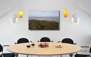An acrylic print of a wave breaking off Surfers Point at Margaret River WA hanging in a dining room setting
