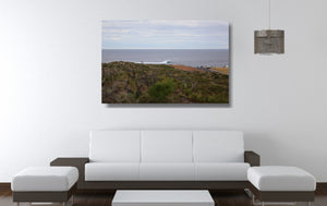 An acrylic print of a wave breaking off Surfers Point at Margaret River WA hanging in a lounge room setting