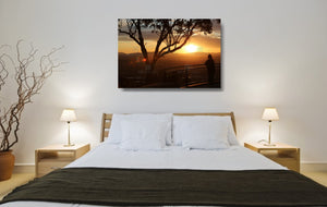 An acrylic print of a lone person standing at a lookout in Tamworth at sunset in hanging in a bed room setting