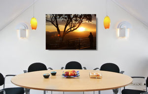 An acrylic print of a lone person standing at a lookout in Tamworth at sunset in hanging in a dining room setting