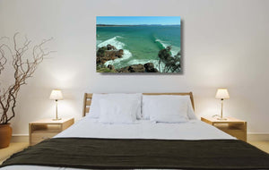 An acrylic print of The Pass at Byron Bay NSW hanging in a bed room setting